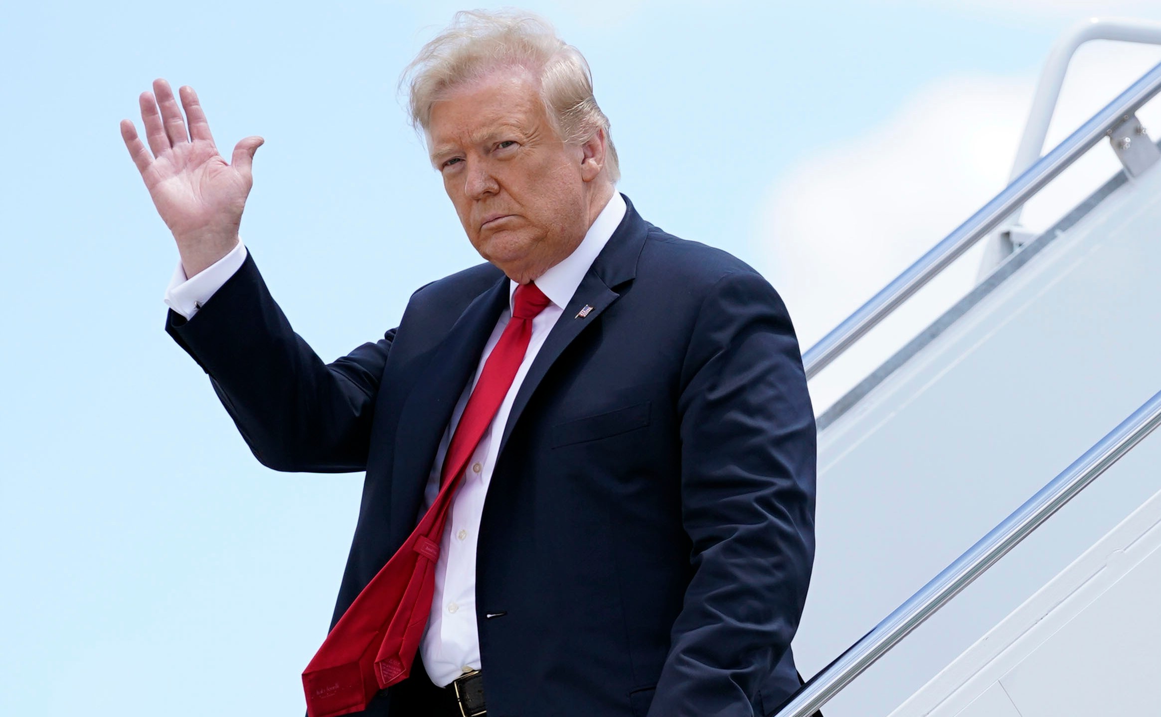 In this Thursday, June 25, 2020 file photo, President Donald Trump waves as he arrives on Air Force One at Austin Straubel International Airport in Green Bay, Wis. (AP Photo/Evan Vucci, File)