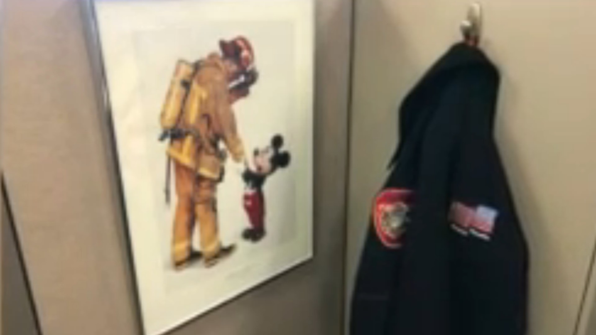 Anaheim Fire Capt. David Baker is pictured with Mickey Mouse in a 1993 photo. (City of Anaheim)