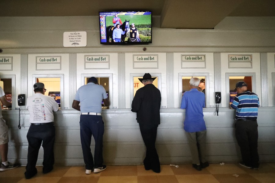 Gamblers stand at betting windows on the final day of the winter/spring horse racing season at Santa Anita Park on June 23, 2019, in Arcadia, California. (Mario Tama/Getty Images)