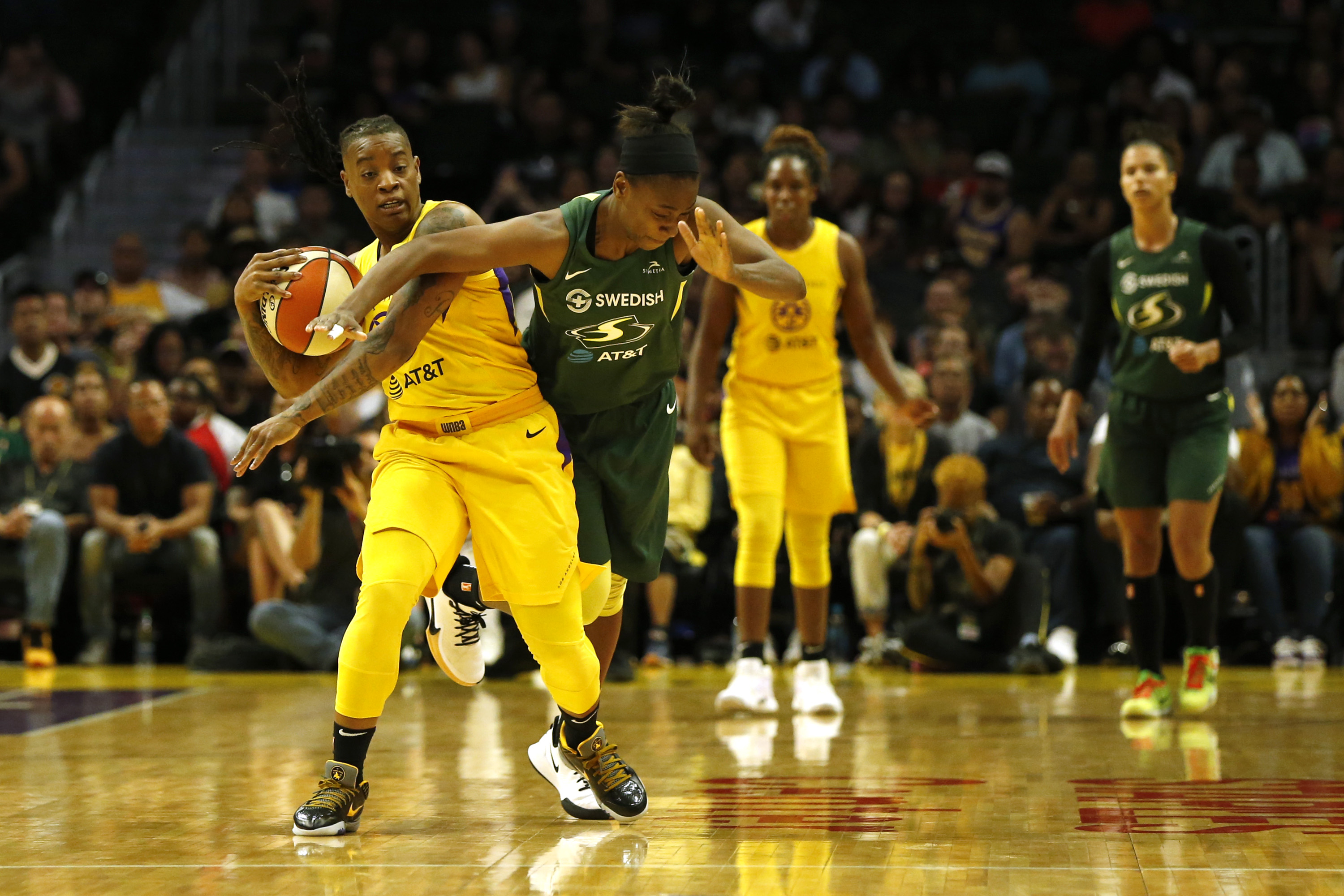 Guard Riquna Williams #2 of the Los Angeles Sparks and guard Jewell Loyd #24 of the Seattle Storm fight for a jump ball during the second half of a game at Staples Center on Sept. 15, 2019. (Katharine Lotze/Getty Images)