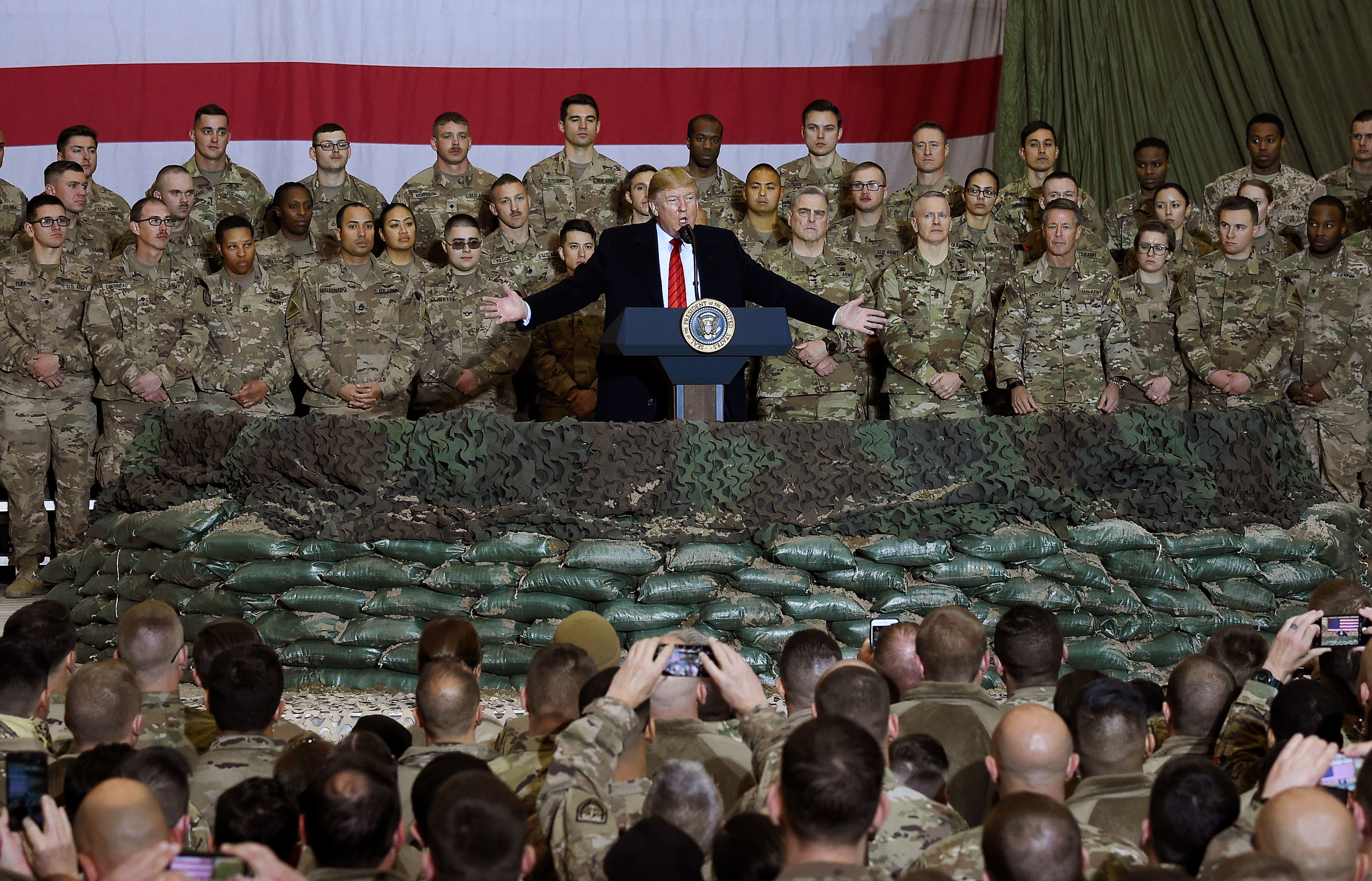 In this photo taken on Nov. 28, 2019, Donald Trump speaks to the troops during a surprise Thanksgiving Day visit at Bagram Air Field in Afghanistan. (OLIVIER DOULIERY/AFP via Getty Images)