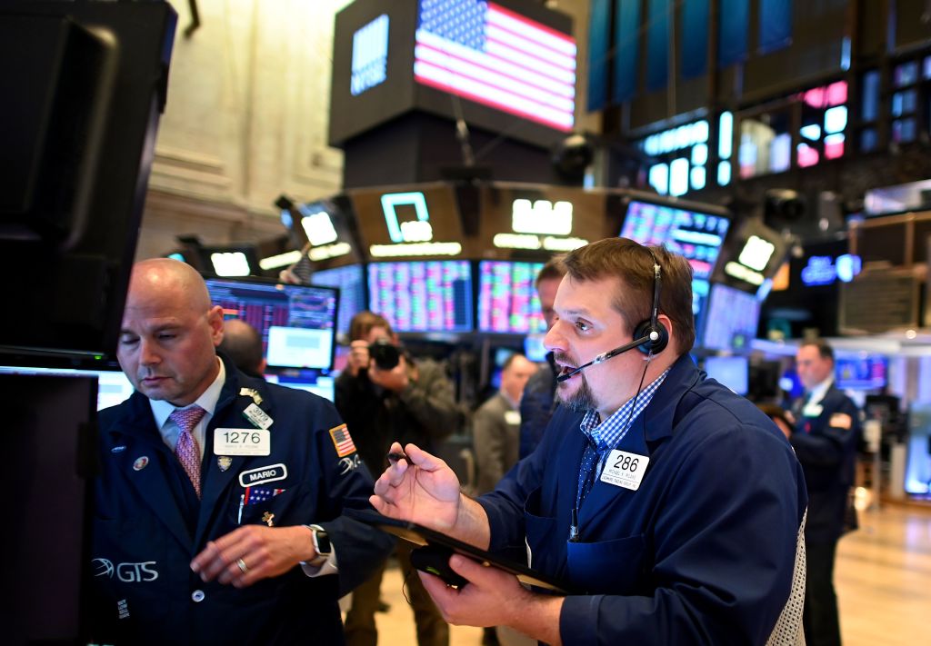 Traders work during the closing bell at the New York Stock Exchange (NYSE) on March 18, 2020 at Wall Street in New York City. - Wall Street stocks plunged again March 18, 2020 as the economic toll from the coronavirus mounts and economists warn of a deep recession.