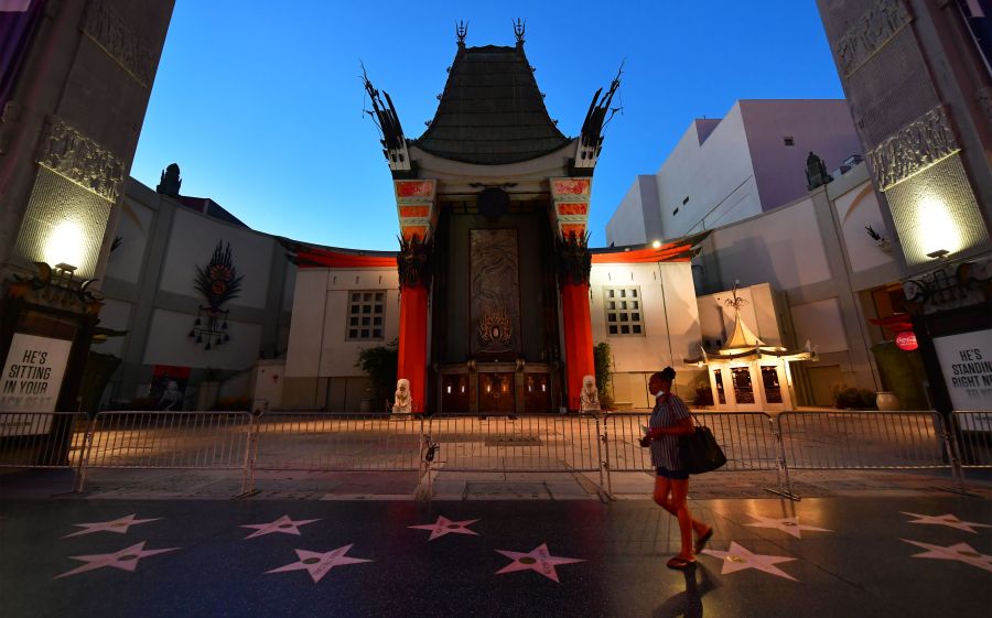 A woman walks past the closed courtyard in front of the TCL Chinese Theater on May 5, 2020 in Hollywood.(FREDERIC J. BROWN/AFP via Getty Images)