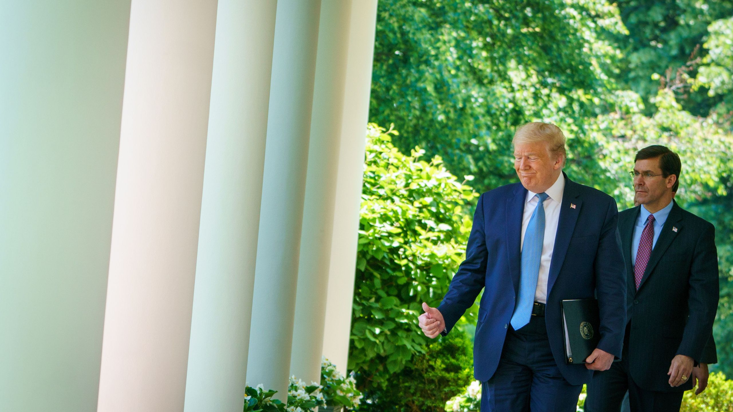 Donald Trump walks with Defense Secretary Mark Esper through the Colonnades at the White House in Washington, D.C. on May 15, 2020. (MANDEL NGAN/AFP via Getty Images)