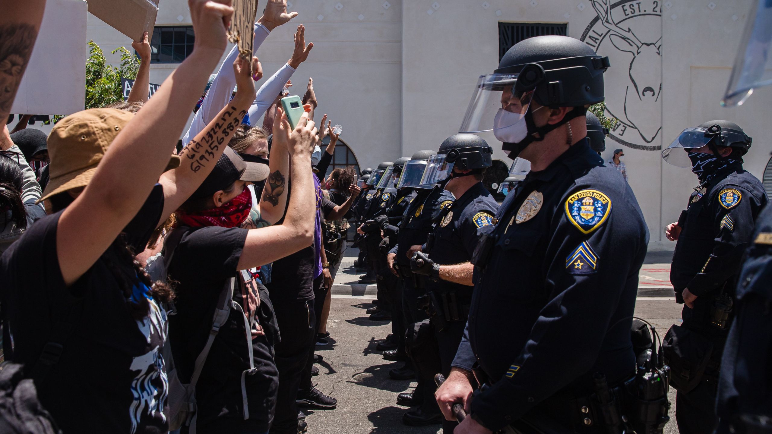 Demonstrators face-off with officers in front of San Diego Police in downtown San Diego, California on May 31, 2020, as they protest the death of George Floyd.(ARIANA DREHSLER/AFP via Getty Images)