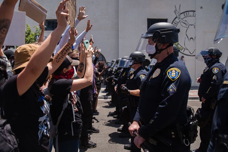 Demonstrators face-off with officers in front of San Diego Police in downtown San Diego, California on May 31, 2020, as they protest the death of George Floyd.(ARIANA DREHSLER/AFP via Getty Images)