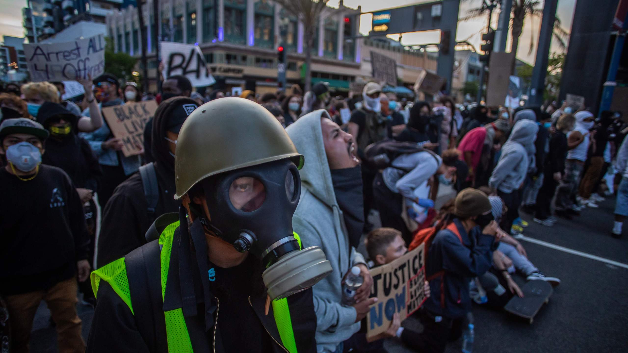 A man wearing a gas mask stands in front of a Police line in Downtown Long Beach on May 31, 2020, during a protest against the death of George Floyd. (APU GOMES/AFP via Getty Images)