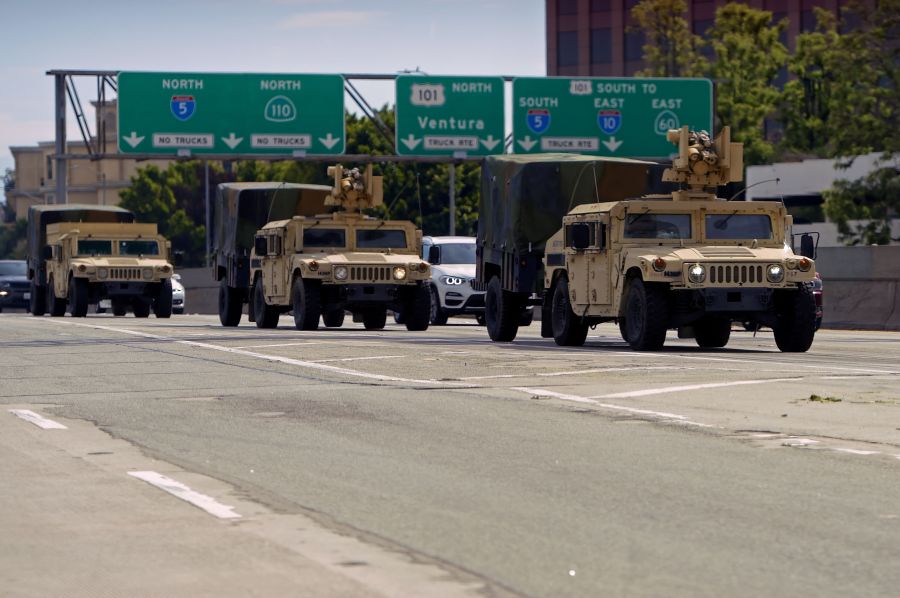 California National Guard armed vehicles are seen on the freeway as they patrol after demonstrators protested the death of George Floyd in Los Angeles on May 31, 2020. (Agustin Paullier / AFP / Getty Images)