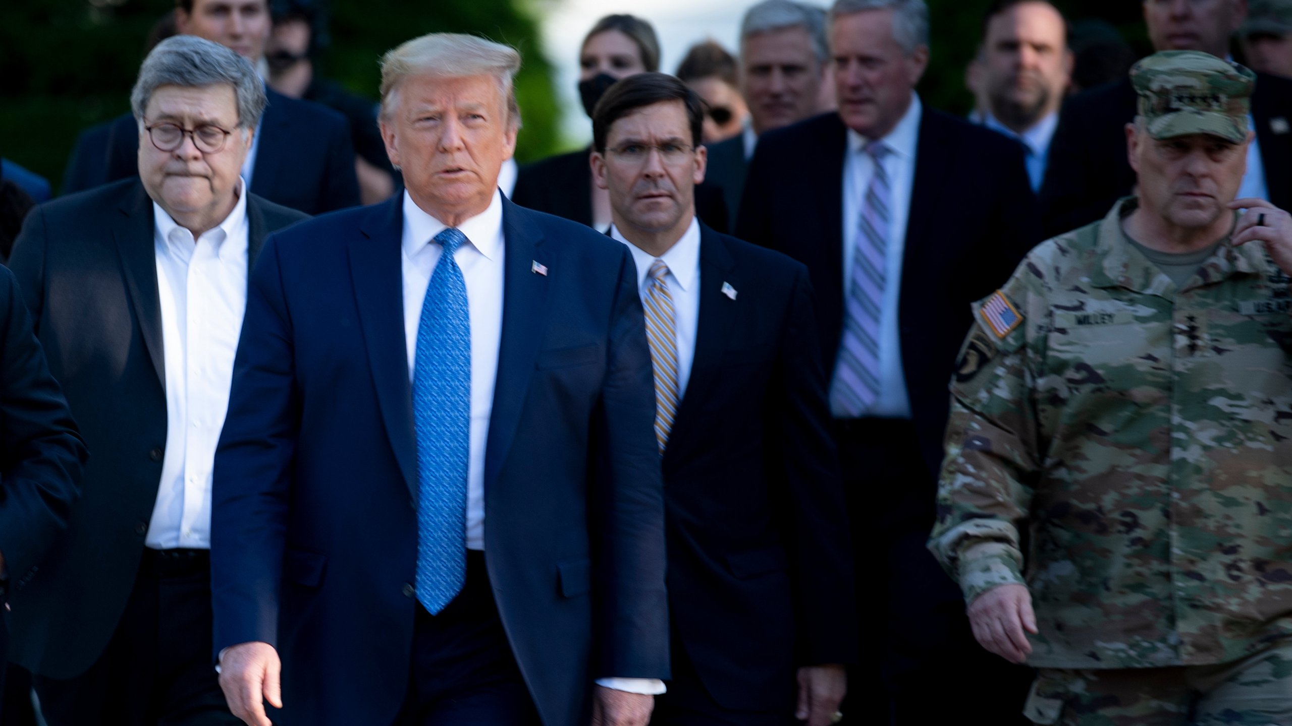 President Donald Trump walks with US Attorney General William Barr (L), US Secretary of Defense Mark T. Esper (C), Chairman of the Joint Chiefs of Staff Mark A. Milley (R), and others from the White House to visit St. John's Church after the area was cleared of people protesting the death of George Floyd June 1, 2020, in Washington, D.C. (BRENDAN SMIALOWSKI/AFP via Getty Images)