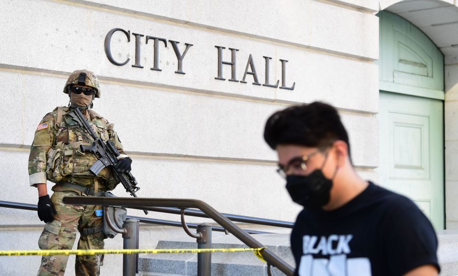 An armed National Guard mans his position in front of Los Angeles City Hall as people protest the death of George Floyd, who died in police custody, on June 3, 2020. (FREDERIC J. BROWN/AFP via Getty Images)