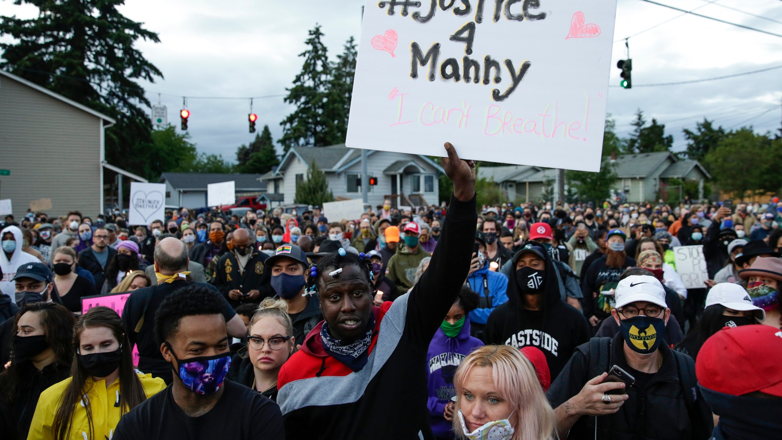 Family, friends and community members attend a vigil at the intersection where Manuel Ellis, a 33-year-old black man, died in Tacoma police custody on March 3 after his death was ruled a homicide on June 3, 2020. (Jason Redmond / AFP / Getty Images)