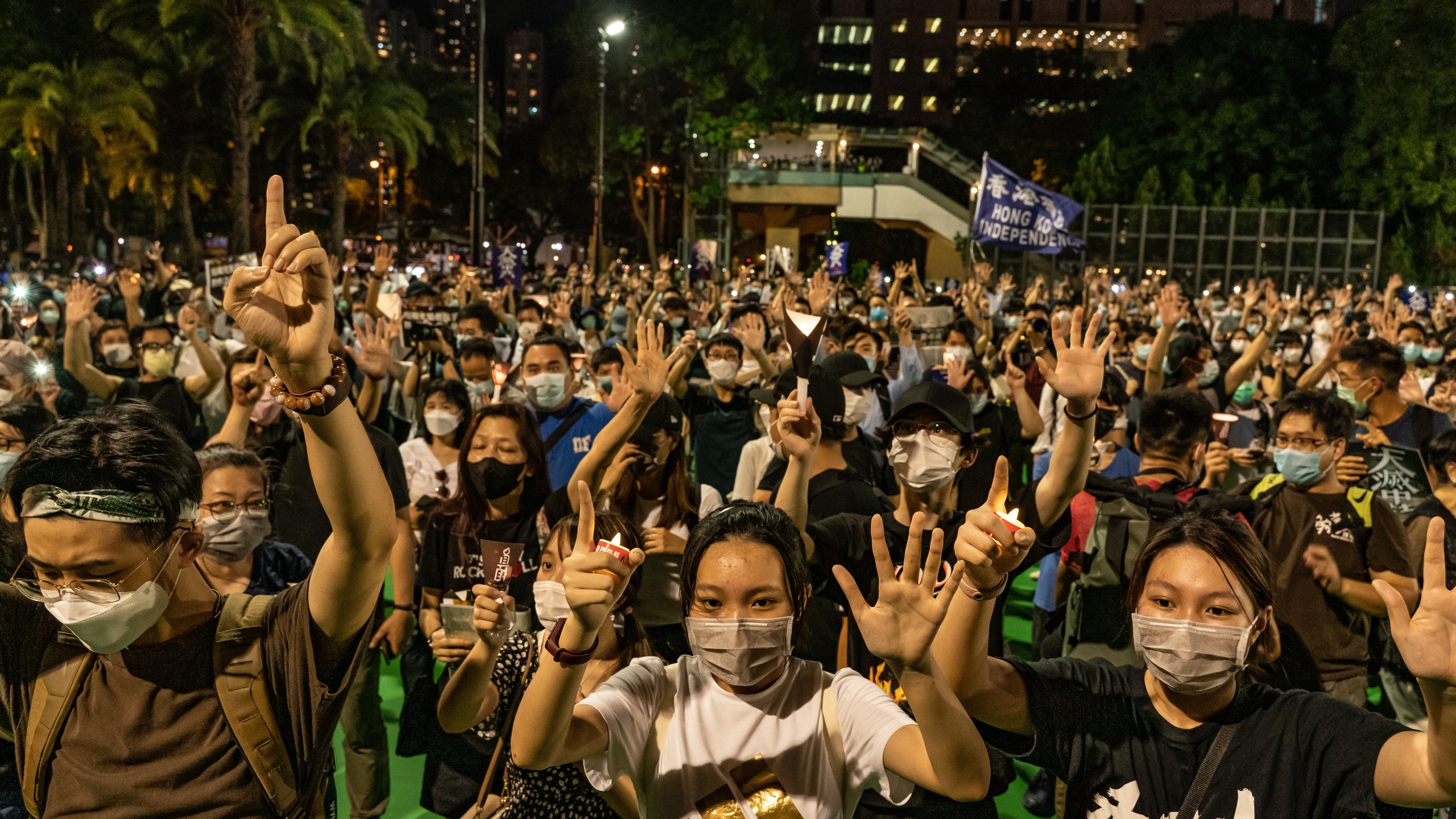 Participants raise their hands as they take part in a memorial vigil in Victoria Park on June 4, 2020, in Hong Kong, China. (Anthony Kwan/Getty Images)