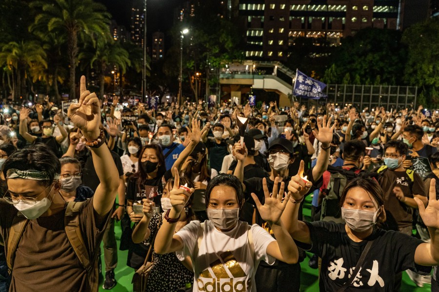 Participants raise their hands as they take part in a memorial vigil in Victoria Park on June 4, 2020, in Hong Kong, China. (Anthony Kwan/Getty Images)