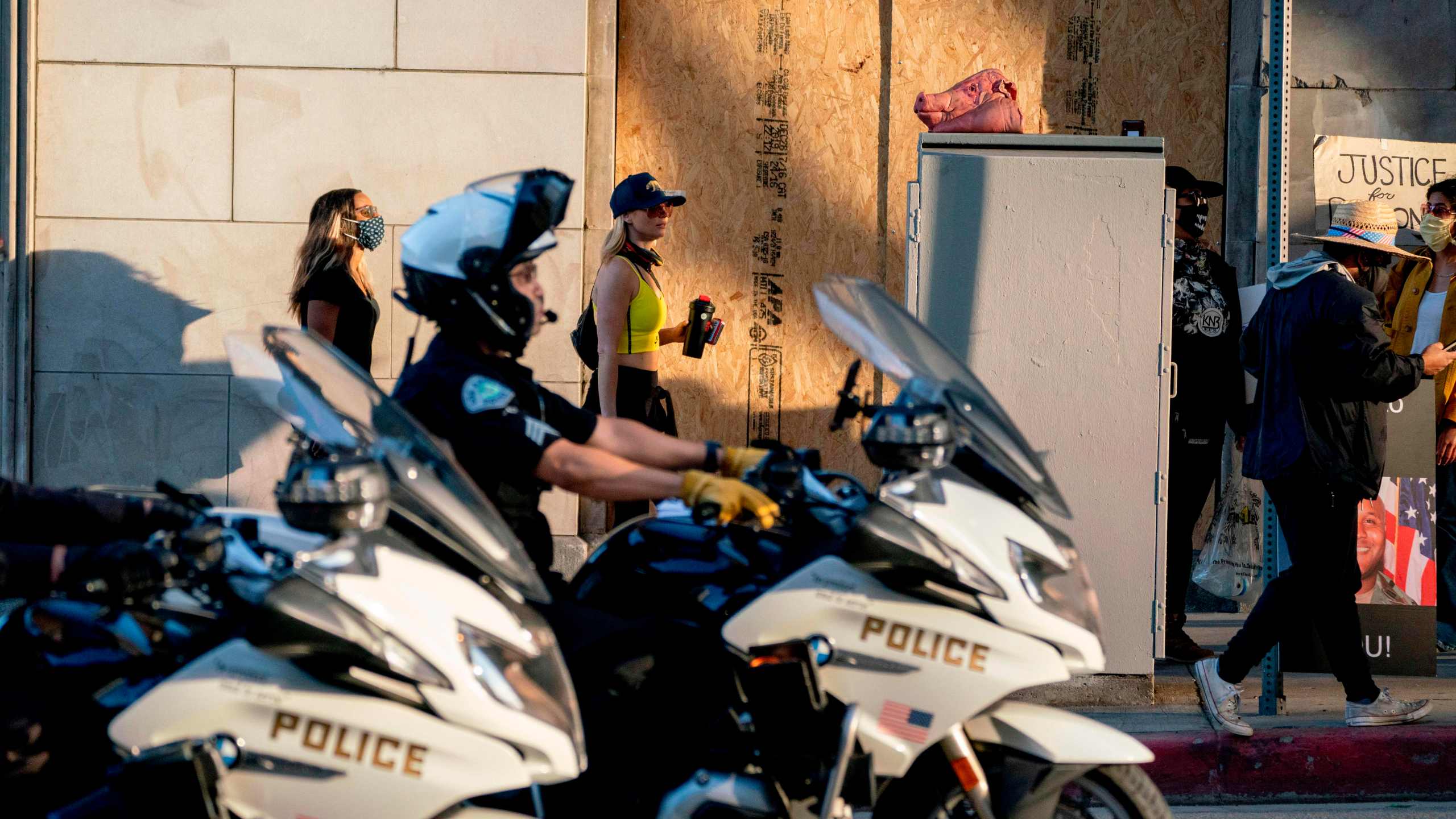 LAPD motorcycle officers drive past protesters during a demonstration over the death of George Floyd on June 6, 2020. (Kyle Grillot/AFP via Getty Images)