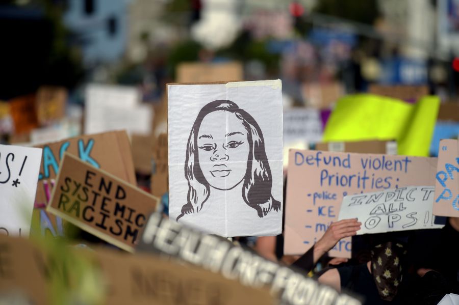 Protesters march holding placards and a portrait of Breonna Taylor during a demonstration against racism and police brutality, in Hollywood on June 7, 2020. (AGUSTIN PAULLIER/AFP via Getty Images)