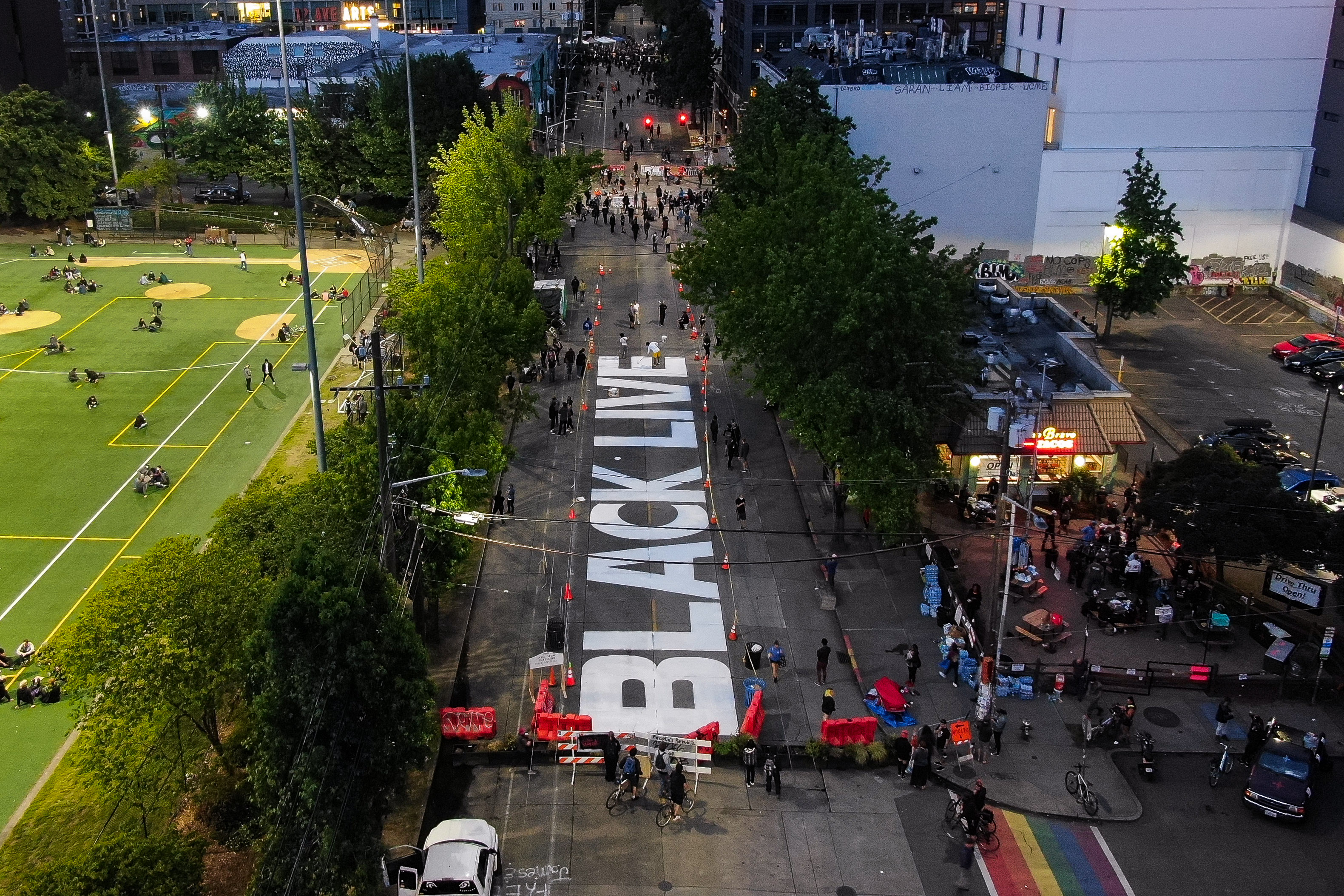 A Black Lives Matter mural begins to take shape on East Pine Street in Seattle's "Capitol Hill Autonomous Zone" on June 10, 2020. (David Ryder / Getty Images)