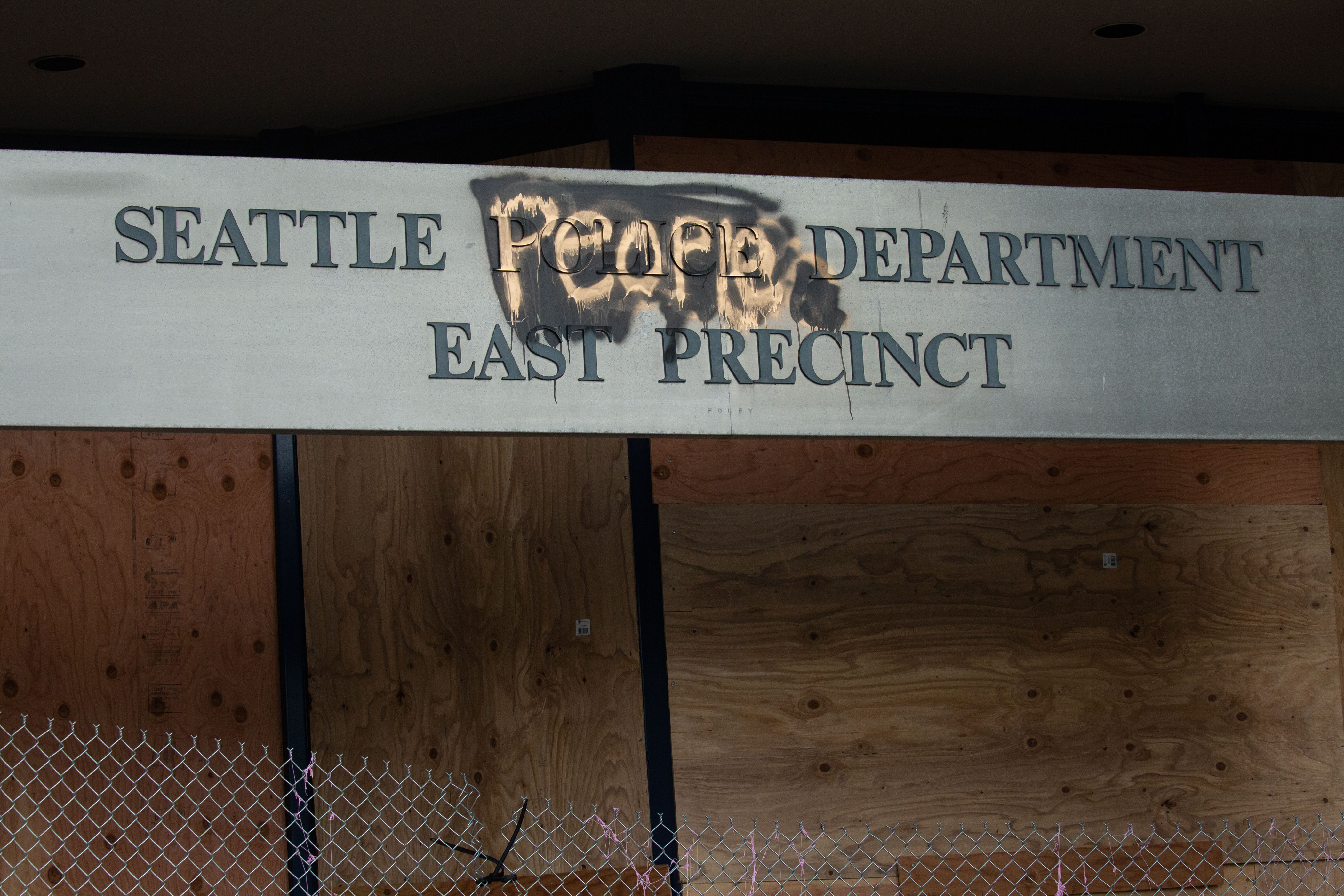 A defaced sign with "People" painted over "Police" is seen on the exterior of the Seattle Police Department's East Precinct in the "Capitol Hill Autonomous Zone" on June 10, 2020. (David Ryder / Getty Images)