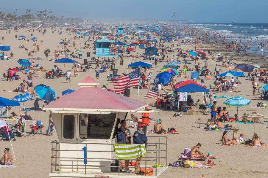 People enjoy the beach amid the coronavirus pandemic in Huntington Beach, on June 14, 2020. (Apu GOMES / AFP) (Photo by APU GOMES/AFP via Getty Images)