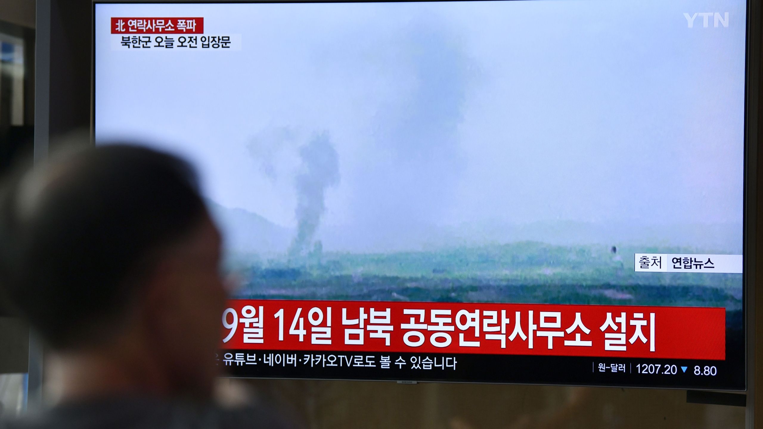 People watch a television news screen showing an explosion of an inter-Korean liaison office in North Korea's Kaesong Industrial Complex, at a railway station in Seoul on June 16, 2020. (JUNG YEON-JE/AFP via Getty Images)