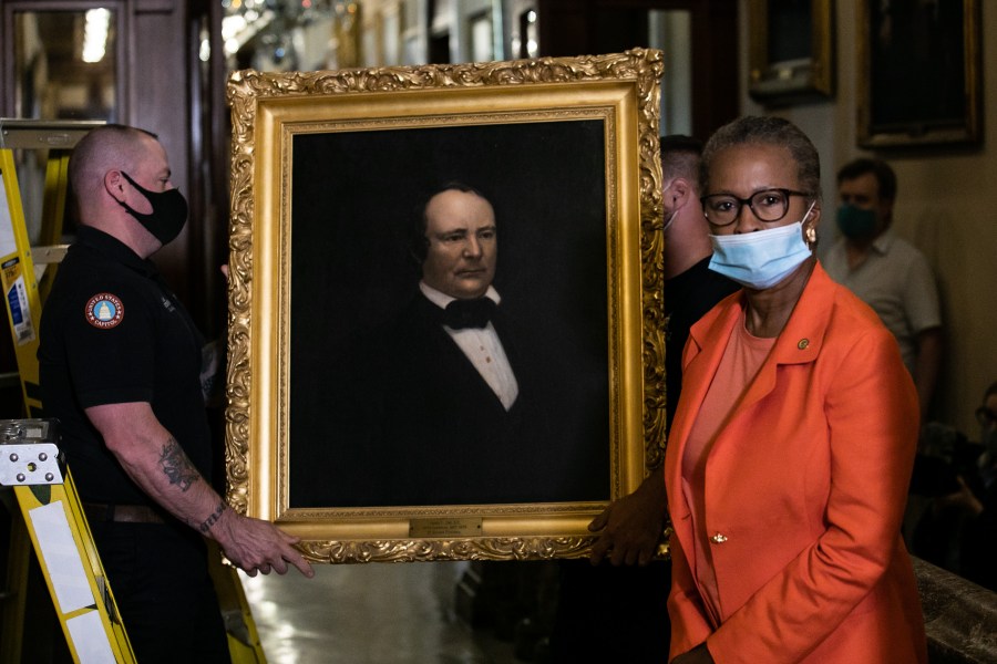 House Clerk Cheryl Johnson looks on as maintenance workers remove a painting of former speaker James Orr of South Carolina, from the east staircase of the Speakers lobby, on Capitol Hill, on June 18, 2020. (Graeme Jennings / Getty Images)