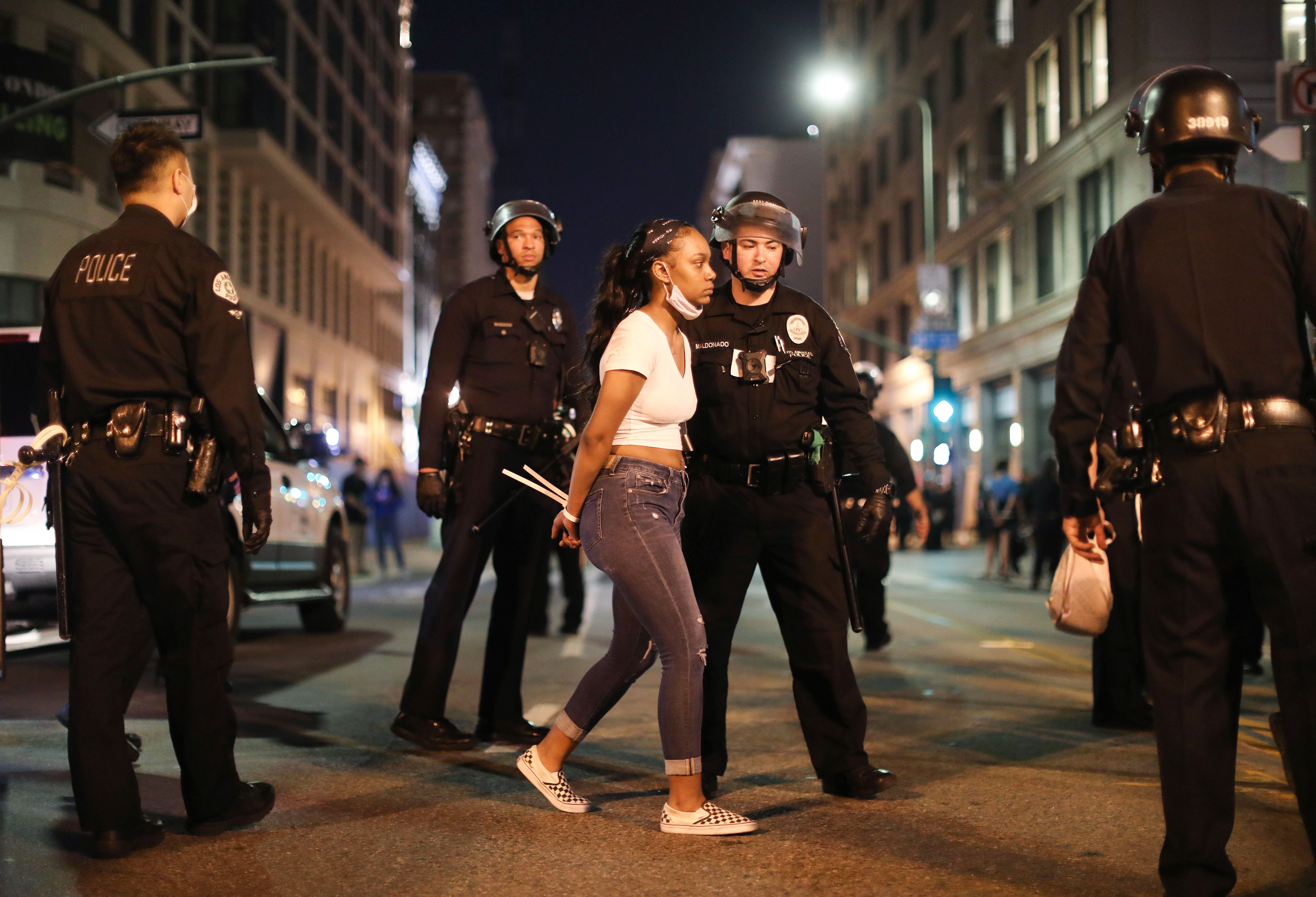 A woman is arrested after curfew went into effect during mostly peaceful demonstrations over George Floyd’s death in downtown Los Angeles on June 2, 2020. (Mario Tama/Getty Images)