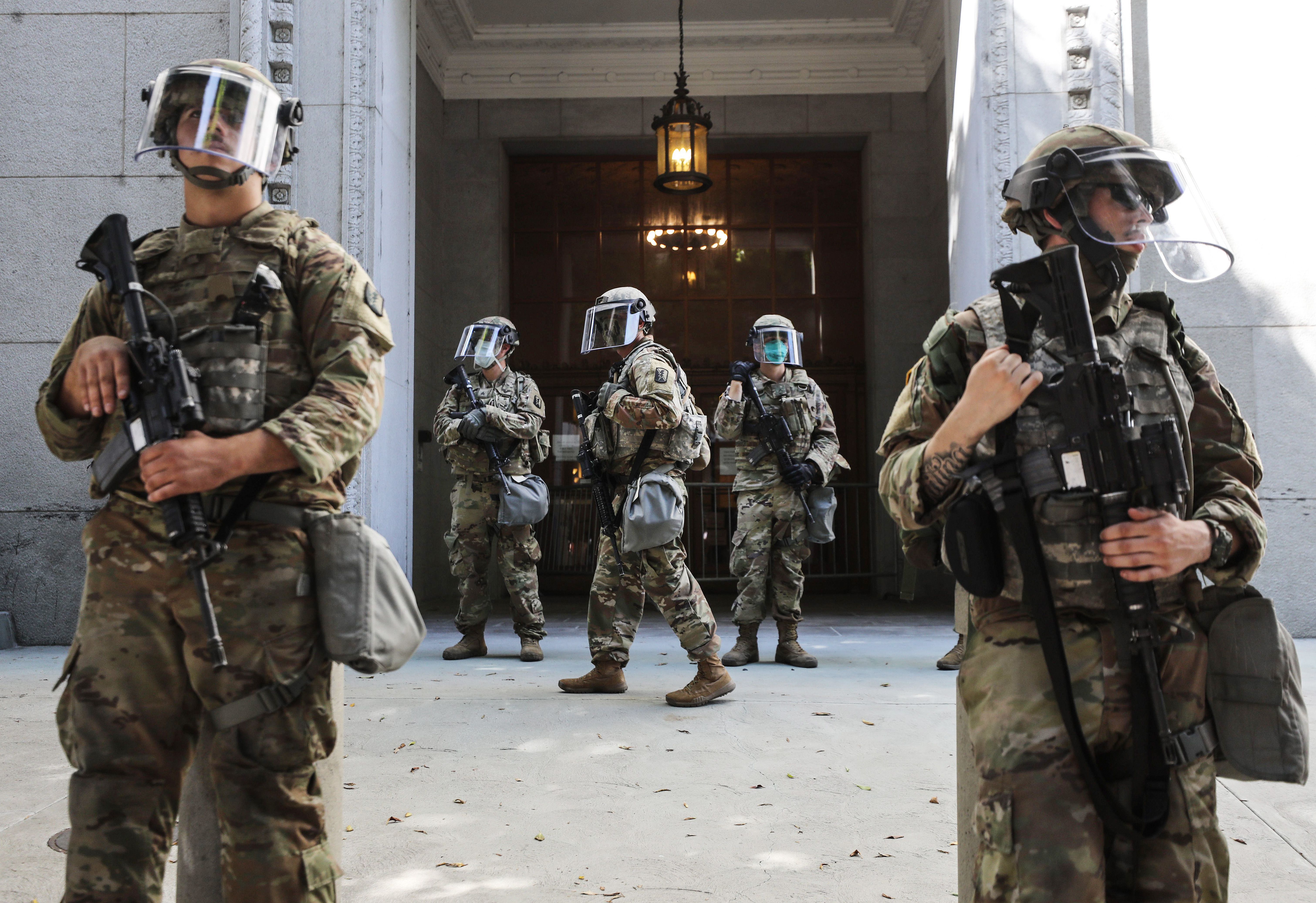 National Guard troops are posted outside the Los Angeles County District Attorney's office during a peaceful demonstration over George Floyd’s death on June 3, 2020. (Mario Tama / Getty Images)