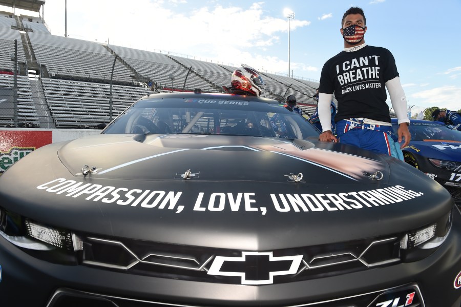 Bubba Wallace, driver of the #43 Richard Petty Motorsports Chevrolet, wears a "I Can't Breathe - Black Lives Matter" t-shirt under his firesuit in solidarity with protesters around the world taking to the streets after the death of George Floyd on May 25, stands next to his car painted with "#Black Lives Matter" prior to the NASCAR Cup Series Blue-Emu Maximum Pain Relief 500 at Martinsville Speedway on June 10, 2020 in Martinsville, Virginia. Jared C. Tilton/Getty Images)