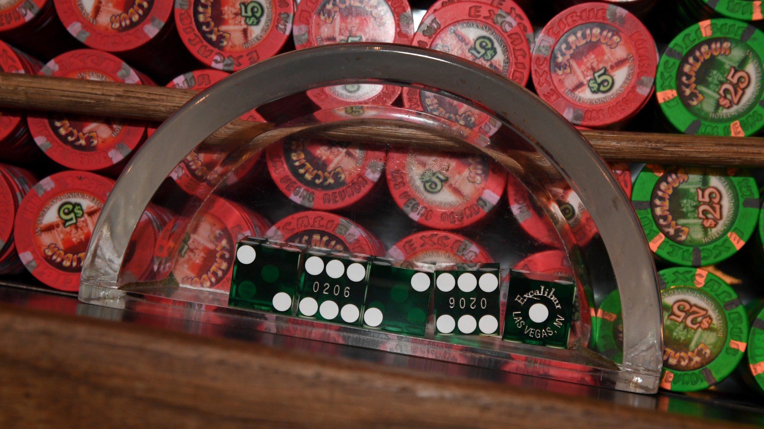 Dice are shown in a glass tray on top of piles of chips at a craps table as part of a sanitization demonstration at Excalibur Hotel and Casino before the Las Vegas strip property opens on June 4, 2020. (Ethan Miller/Getty Images)