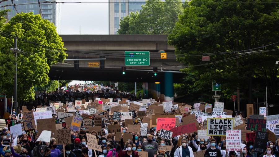 Healthcare workers and others march to Seattle City Hall during the Doctors For Justice event on June 6, 2020 in Seattle, Washington. This is the 12th day of protests since George Floyd died in Minneapolis police custody on May 25. (David Ryder/Getty Images)