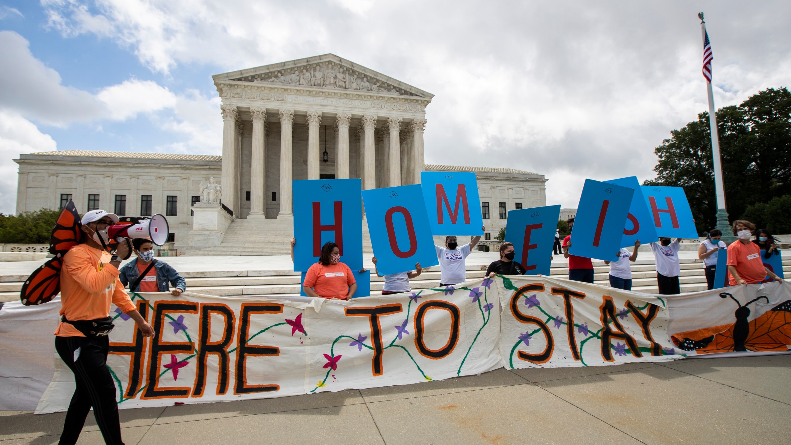 Deferred Action for Childhood Arrivals (DACA) recipient Roberto Martinez, left, celebrates with other DACA recipients in front of the Supreme Court on June 18, 2020, in Washington.(Manuel Balce Ceneta / Associated Press)