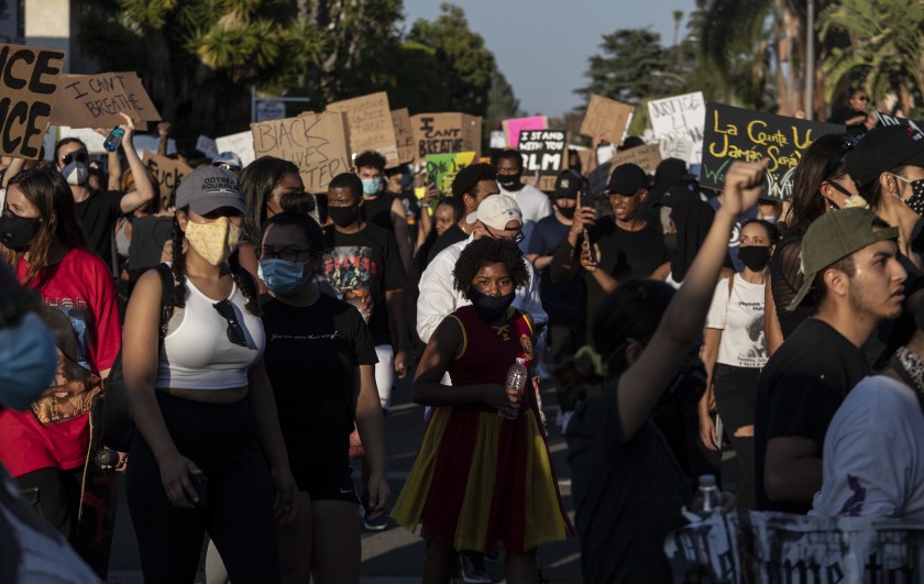 Protesters walk through a residential neighborhood in Hollywood on June 3, 2020, after encountering an LAPD skirmish line.(Brian van der Brug / Los Angeles Times)