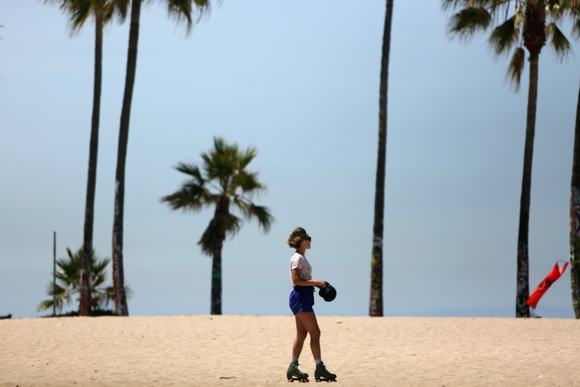 A woman skates along Venice Beach in June 2020. (Dania Maxwell / Los Angeles Times)