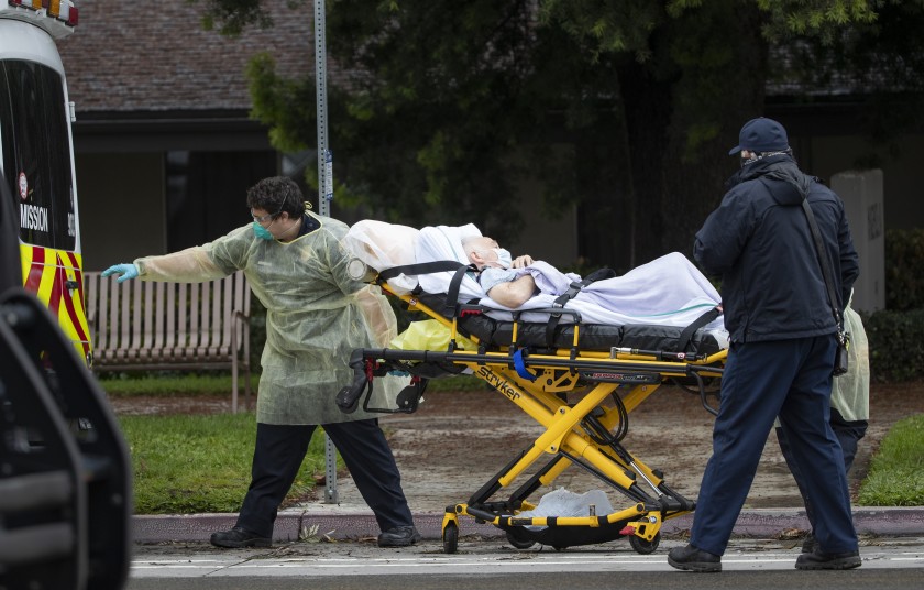 Paramedics load Bernie Erwig, 84, into an ambulance while he was removed from Magnolia Rehabilitation and Nursing Center on April 8, 2020, in Riverside.(Gina Ferazzi / Los Angeles Times)