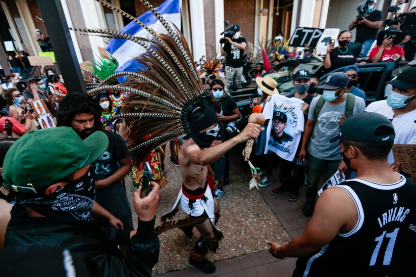 Aztec dancers join others outside the Compton sheriff’s station to protest the fatal shooting of Andres Guardado, an 18-year-old security guard.(Jason Armond / Los Angeles Times)