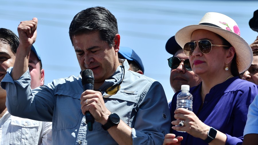 Honduran President Juan Orlando Hernandez speaks to his supporters next to his wife Ana Garcia Hernandez in Tegucigalpa on Oct. 20, 2019. (ORLANDO SIERRA/AFP via Getty Images)