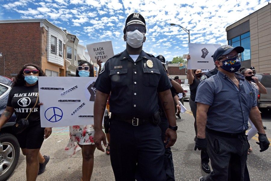 In this May 30, 2020, photo, Lt. Zack James of the Camden County Metro Police Department marches along with demonstrators in Camden, N.J., to protest the death of George Floyd in Minneapolis. (April Saul via CNN)