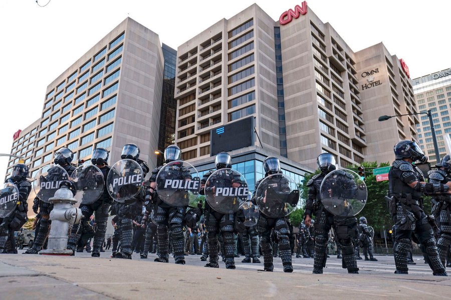 Police stand guard around the CNN Center and Centennial Olympic park as protests continue over the death of George Floyd, Saturday, May 30, 2020, in Atlanta. (Ben Gray/Atlanta Journal-Constitution/AP)