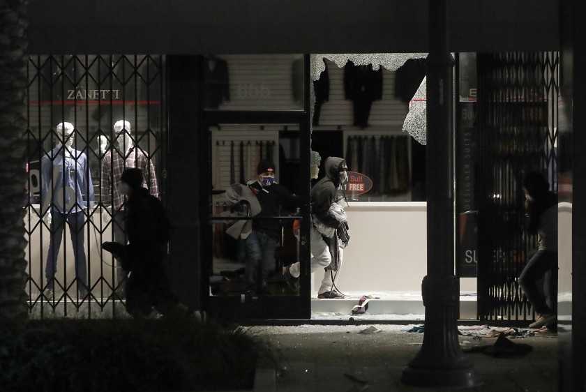 Looters ransack a clothing store on Pine Avenue in Long Beach on May 31, 2020. (Luis Sinco / Los Angeles Times)