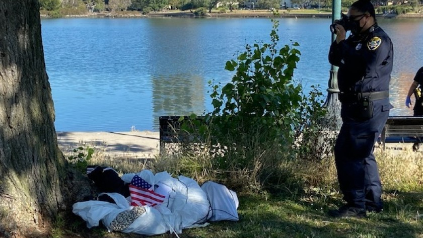 An effigy, a fake dead body, is investigated at Lake Merritt in Oakland on June 18, 2020, amid controversy over apparent nooses found hanging from trees the day before. (Oakland Police Department)