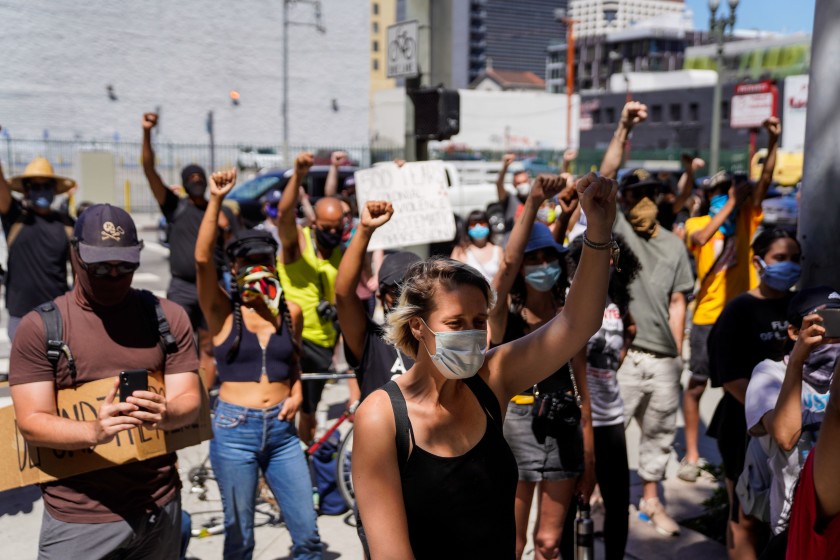 Demonstrators gather at a rally outside the Reagan State Building Friday in downtown Los Angeles in June 2020 to advocate for the removal of a statue of Christopher Columbus outside the State Capitol in Sacramento. (Kent Nishimura / Los Angeles Times)