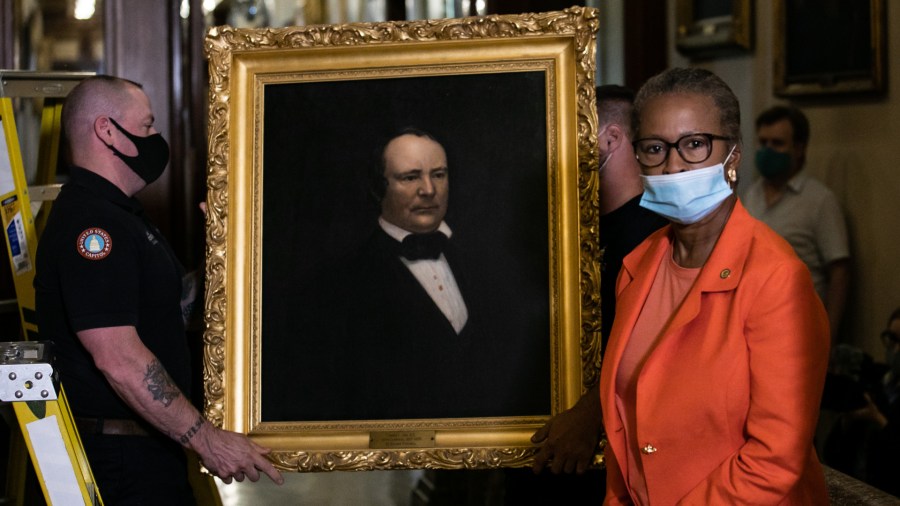 House Clerk Cheryl Johnson looks on as maintenance workers remove a painting of former speaker James Orr of South Carolina, from the east staircase of the Speakers lobby, on Capitol Hill, on June 18, 2020. (Graeme Jennings / Getty Images)