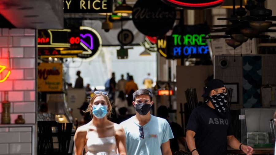 People wear face coverings at Grand Central Market in downtown Los Angeles on Thursday.(Kent Nishimura / Los Angeles Times)