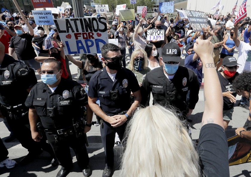 LAPD officers form a line to separate pro- and anti-police demonstrators outside LAPD headquarters in downtown Los Angeles on July 11, 2020. (Luis Sinco/Los Angeles Times)