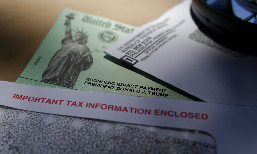 President Donald Trump's name is seen on a stimulus check issued by the IRS to help combat the adverse economic effects of the COVID-19 outbreak, in San Antonio, Thursday, April 23, 2020. (AP Photo/Eric Gay)