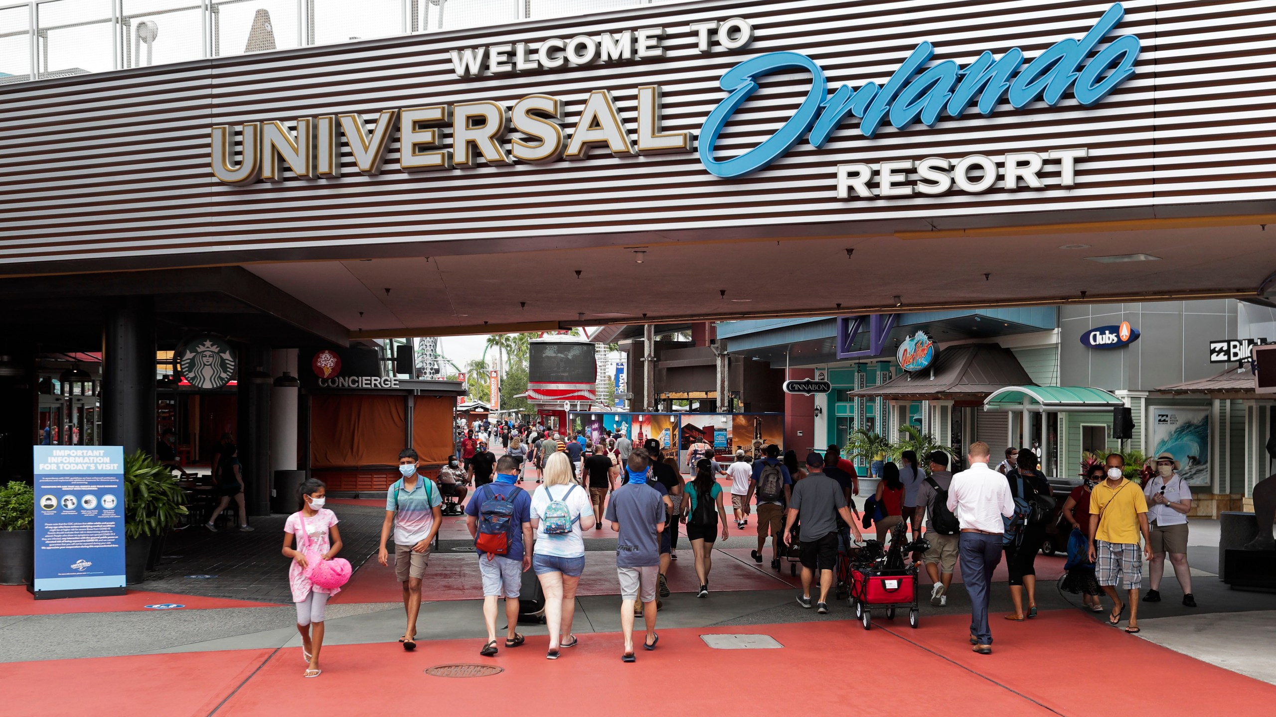 In this June 3, 2020 file photo, visitors arrive at Universal Studios, in Orlando, Fla. Amusement parks of all sizes are adjusting everything from selling tickets to serving meals while trying to reassure the public and government leaders that they're safe to visit amid the coronavirus crisis and warnings against large gatherings. (AP Photo/John Raoux, File)