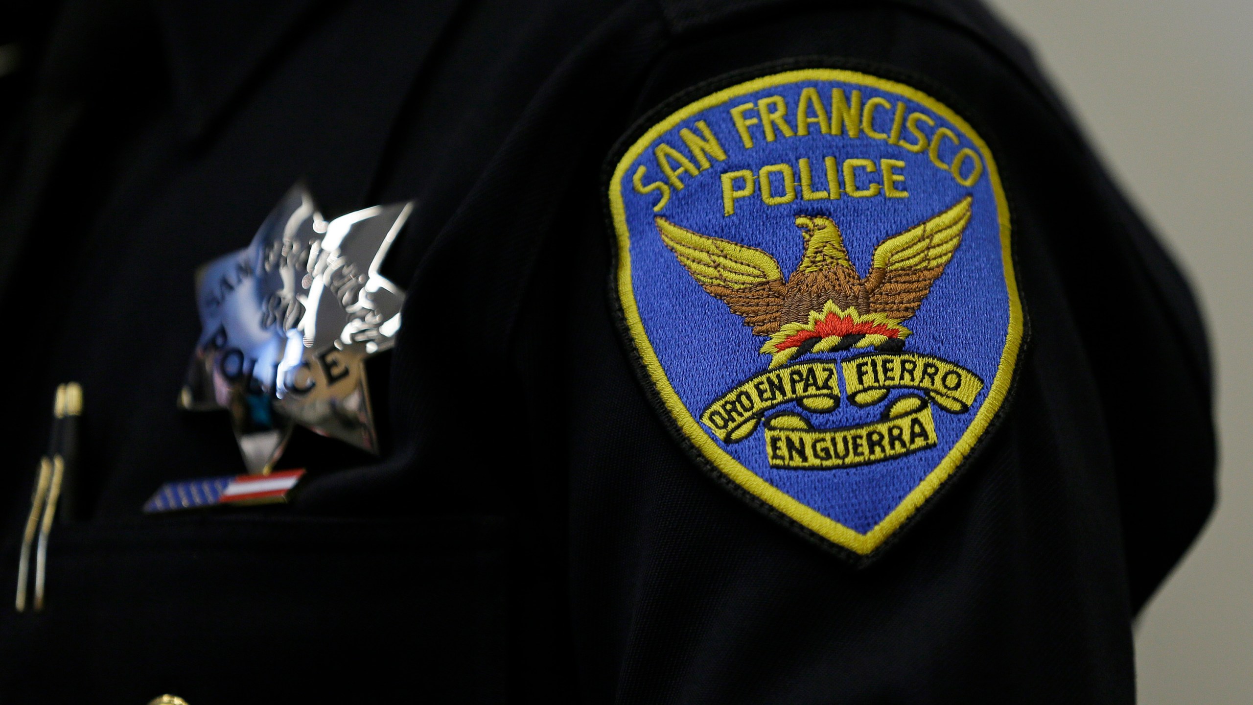 This April 29, 2016, file photo, shows a patch and badge on the uniform of a San Francisco police officer in San Francisco. The San Francisco Police Department will stop releasing mugshots of people arrested unless they pose a threat in an effort to stop perpetuating racial stereotypes, the police chief announced Wednesday, July 1, 2020. (AP Photo/Eric Risberg, File)