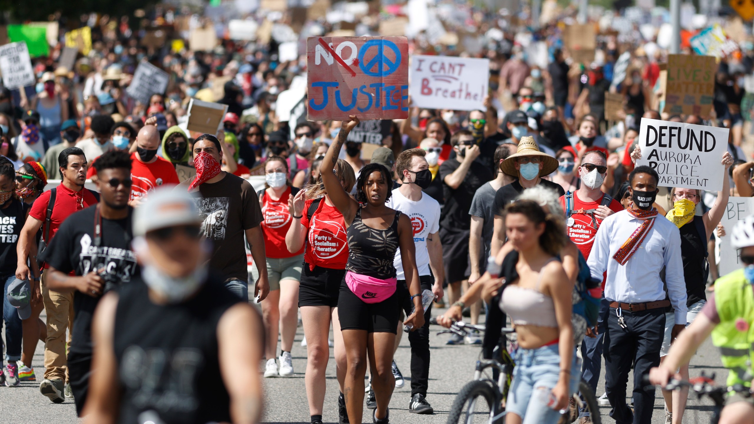 In this Saturday, June 27, 2020, file photo, demonstrators march down Sable Boulevard during a rally and march over the death of 23-year-old Elijah McClain, in Aurora, Colorado. (David Zalubowski / Associated Press)