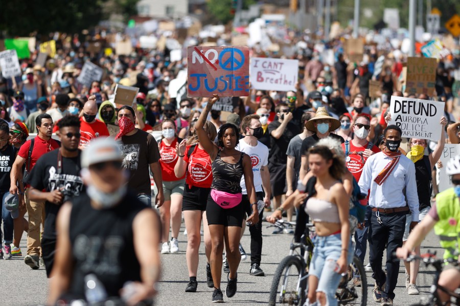 In this Saturday, June 27, 2020, file photo, demonstrators march down Sable Boulevard during a rally and march over the death of 23-year-old Elijah McClain, in Aurora, Colorado. (David Zalubowski / Associated Press)