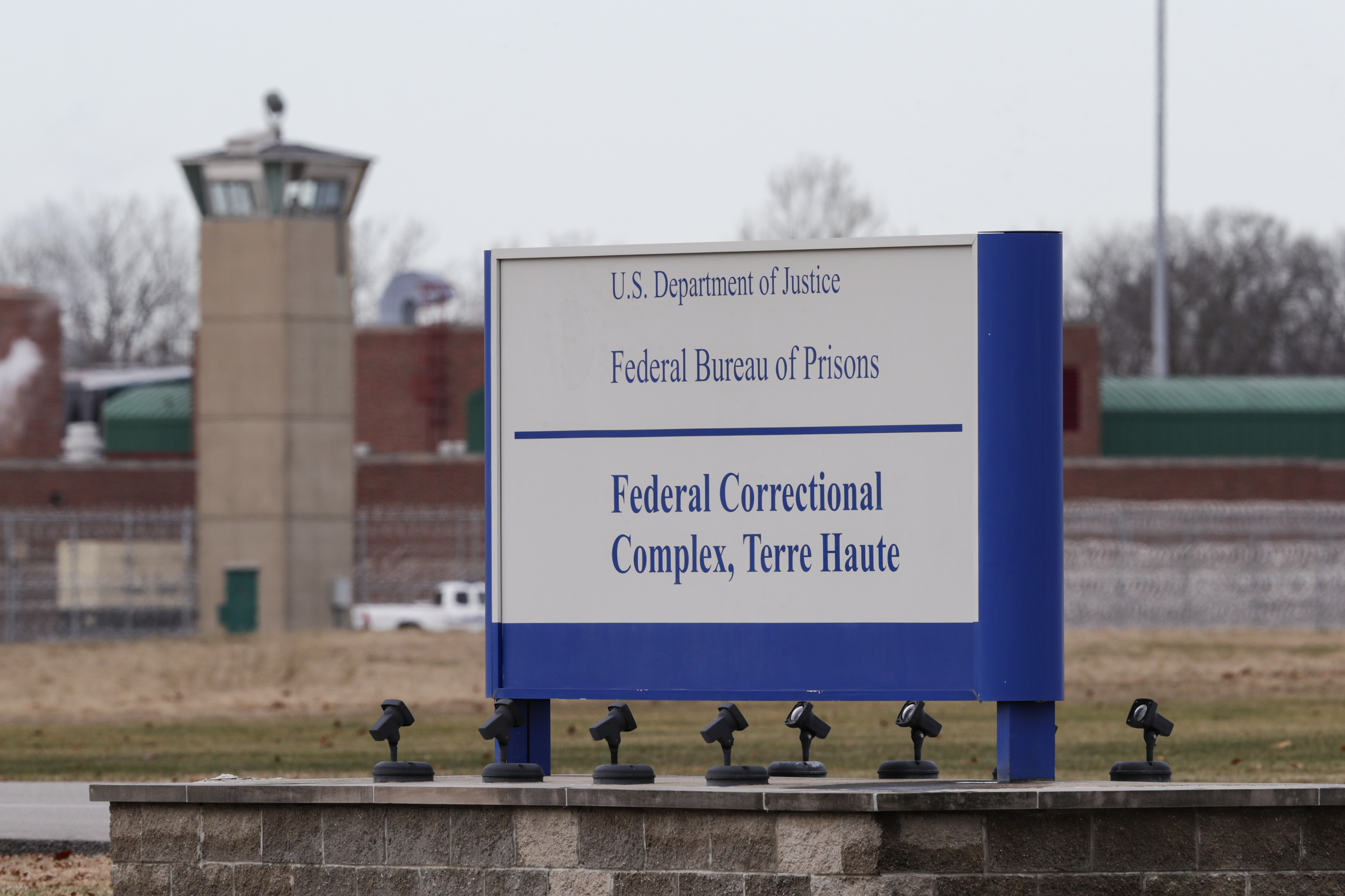 The guard tower flanks the sign at the entrance to the U.S. Penitentiary in Terre Haute, Indiana, on Dec. 10, 2019. (Michael Conroy / Associated Press)