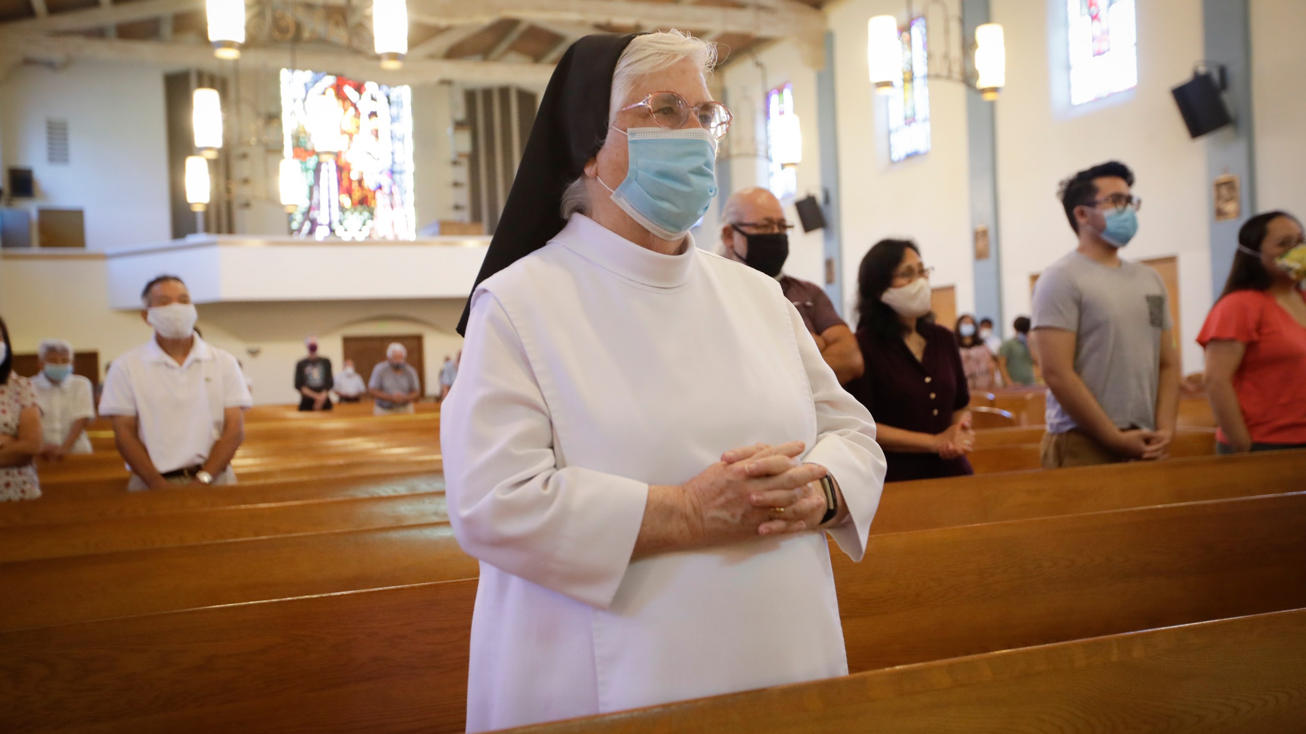 A nun wears a face mask during a service at the San Gabriel Mission, Sunday, July 12, 2020, in San Gabriel amid the coronavirus pandemic. (AP Photo/Marcio Jose Sanchez)